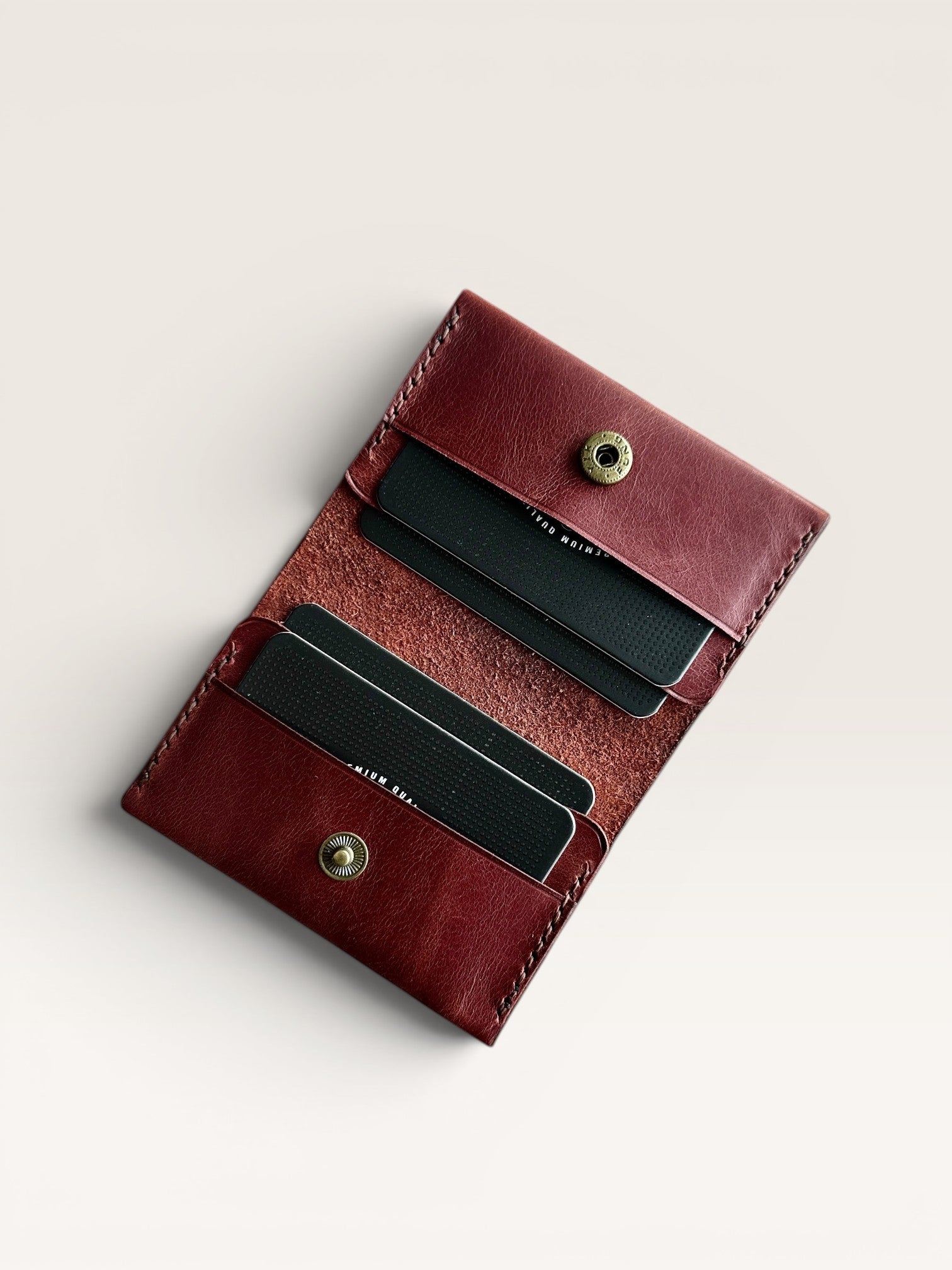 Safir Leather burgundy genuine leather handmade cardholder with 4 card slots and a snap closure. Minimalist unisex design.