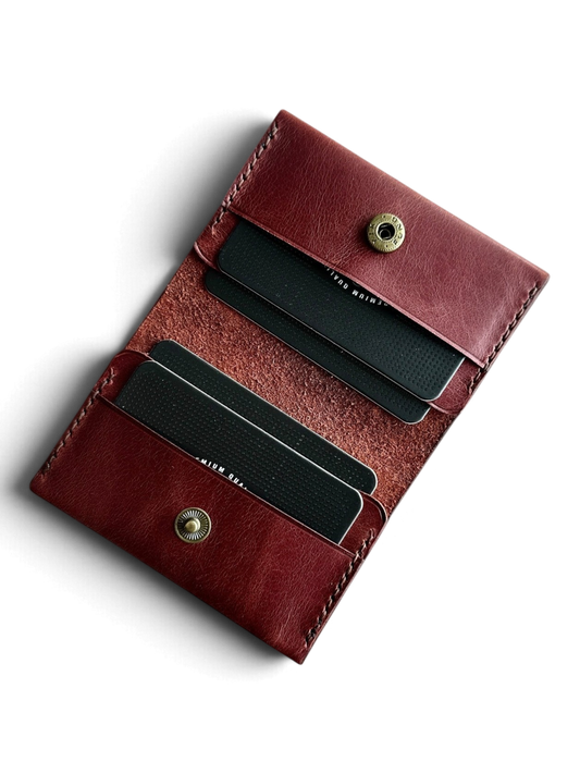 Safir Leather burgundy genuine leather handmade cardholder with 4 card slots and a snap closure. Minimalist unisex design.