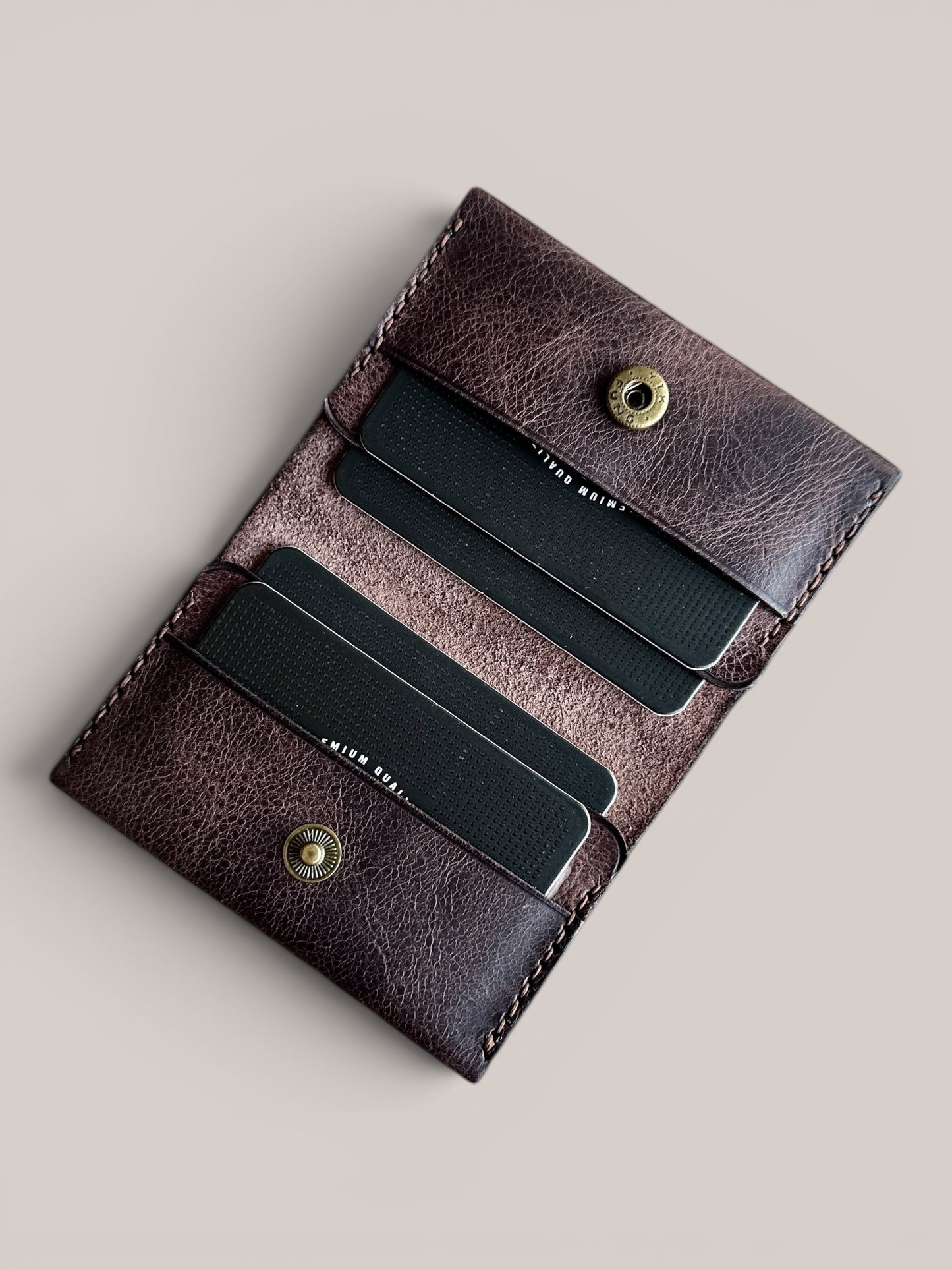 Safir Leather dark brown genuine leather handmade card holder with 4 slots and a snap closure. Minimalist vintage design.