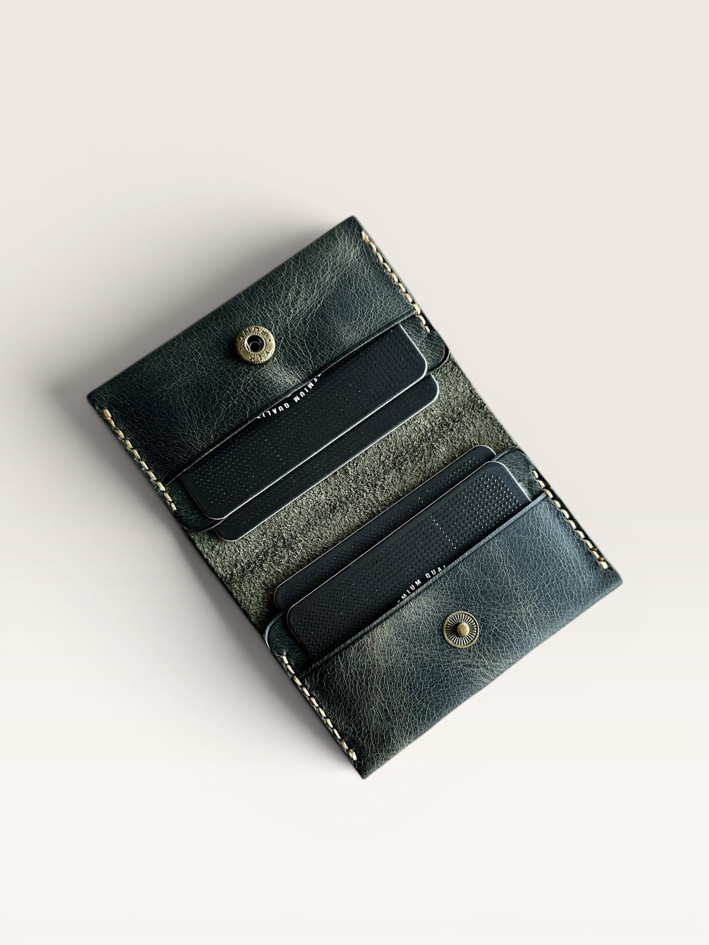 Safir Leather dark green handmade genuine leather card holder with 4 slots and brass snap closure. Minimalist design for men and women.