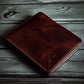 Safir Leather handmade dark brown genuine Italian leather bifold wallet with embossed logo and contrast stitching.