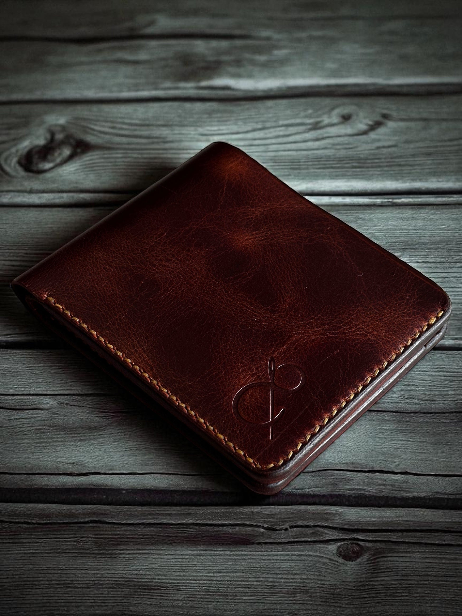 Safir Leather handmade dark brown genuine Italian leather bifold wallet with embossed logo and contrast stitching.