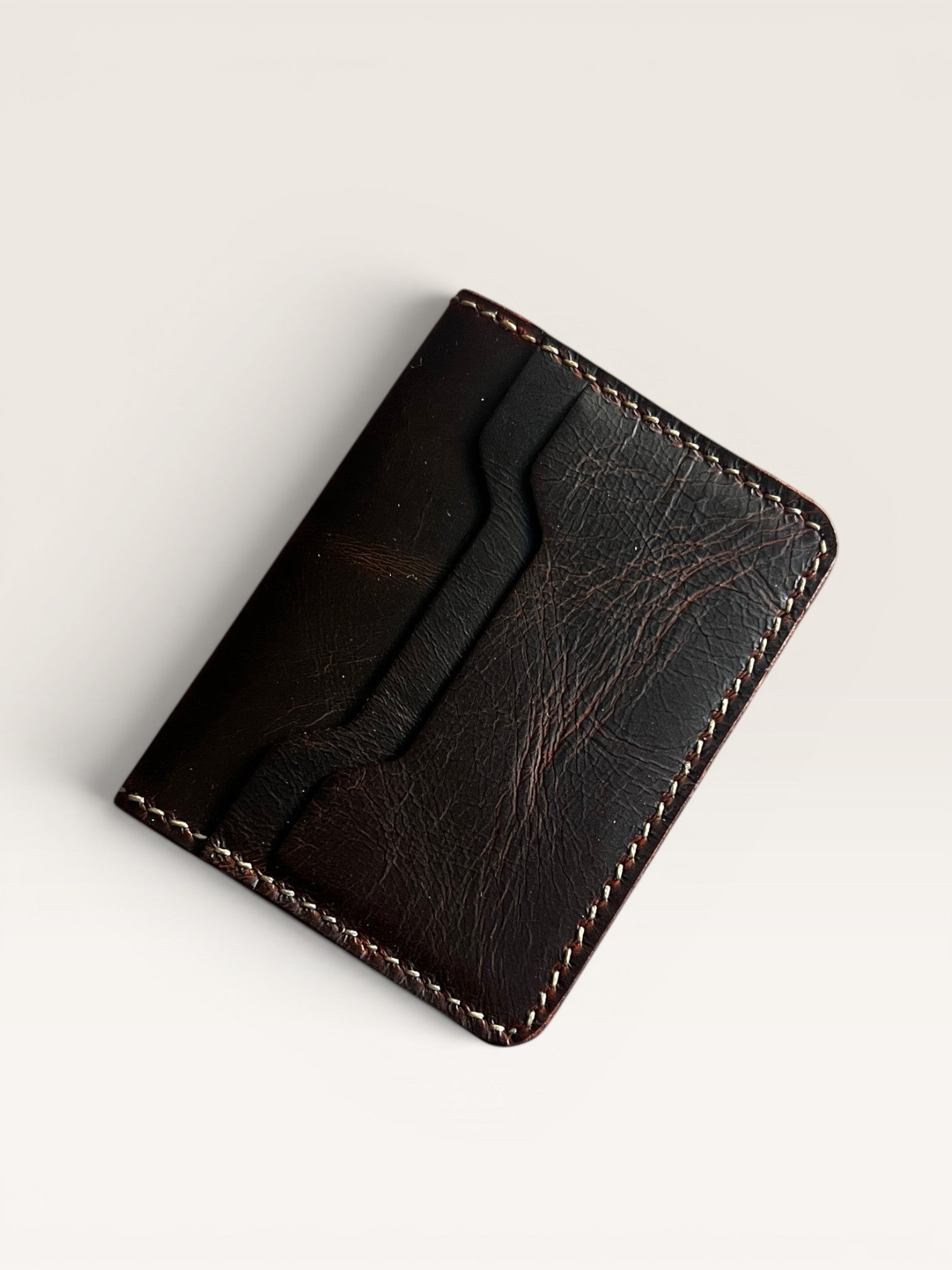Safir Leather Italian dark brown distressed leather minimalist cardholder wallet with white stitching.
