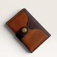 Safir Leather minimal cardholder made of genuine tan and dark brown leather with a brass snap closure.