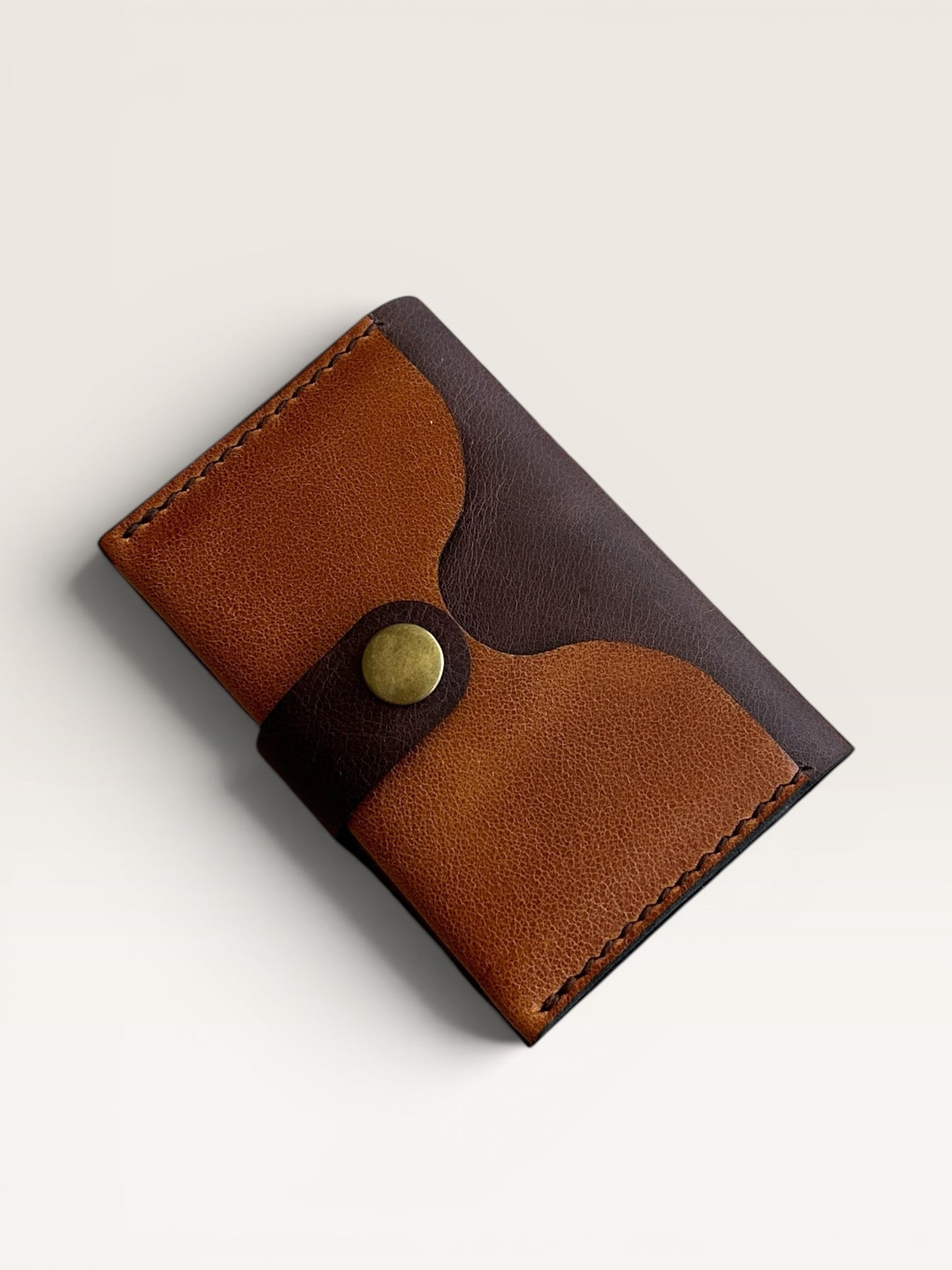 Safir Leather minimal cardholder made of genuine tan and dark brown leather with a brass snap closure.