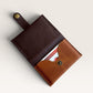Safir Leather minimalist card holder in dark brown and tan genuine leather with brass snap closure.