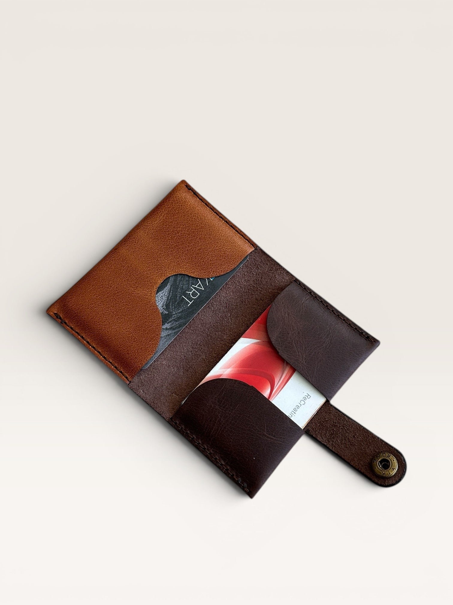 Safir Leather minimalist card holder made of genuine brown and dark brown leather. Features multiple card slots and a snap closure.